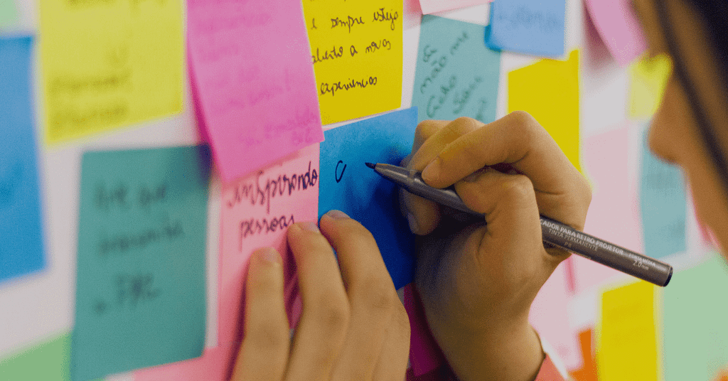 Girl planning in sticky notes to improve herself and transforming her life in positive way