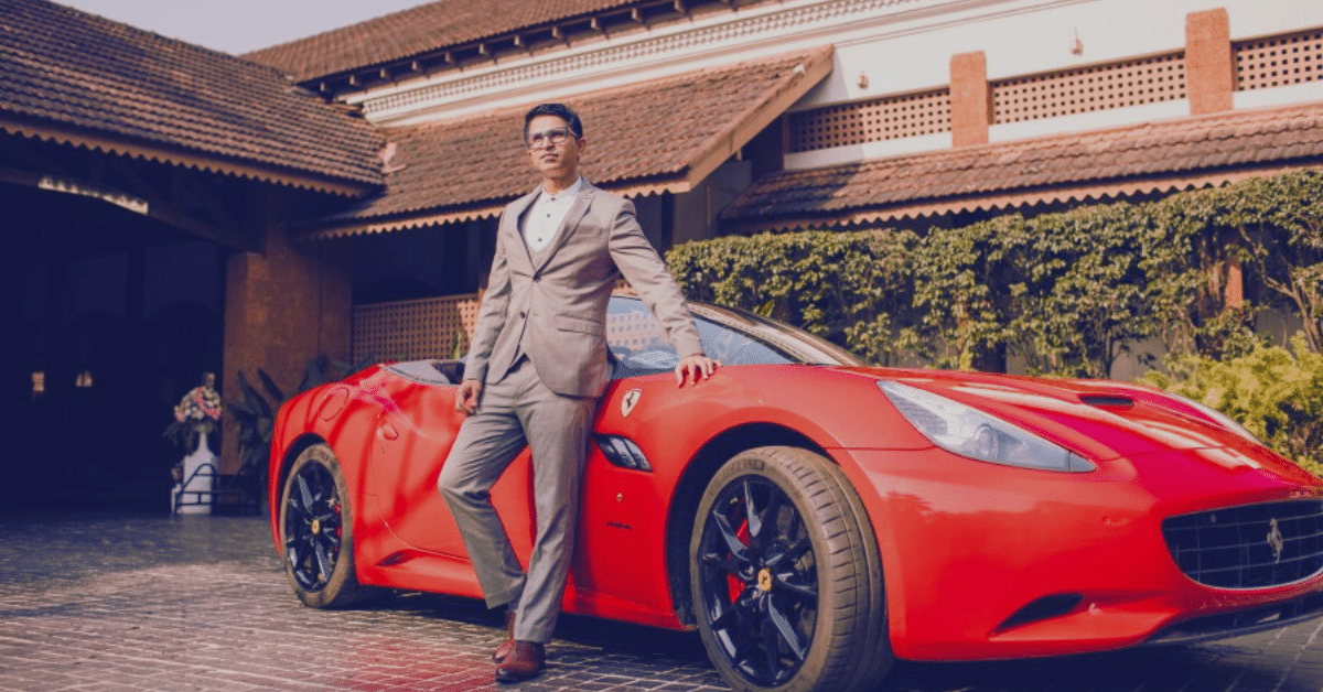 Businessman Dev Gadhvi standing near his luxury Ferrari car.